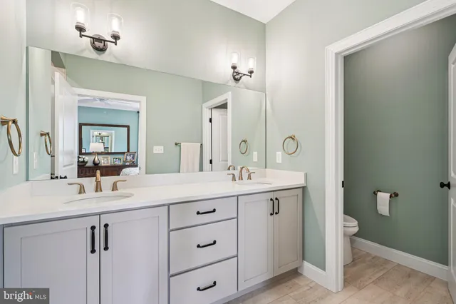 a bathroom with a double vanity sink and a mirror
