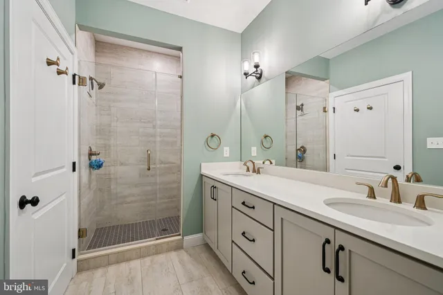 a bathroom with a shower sink and mirror