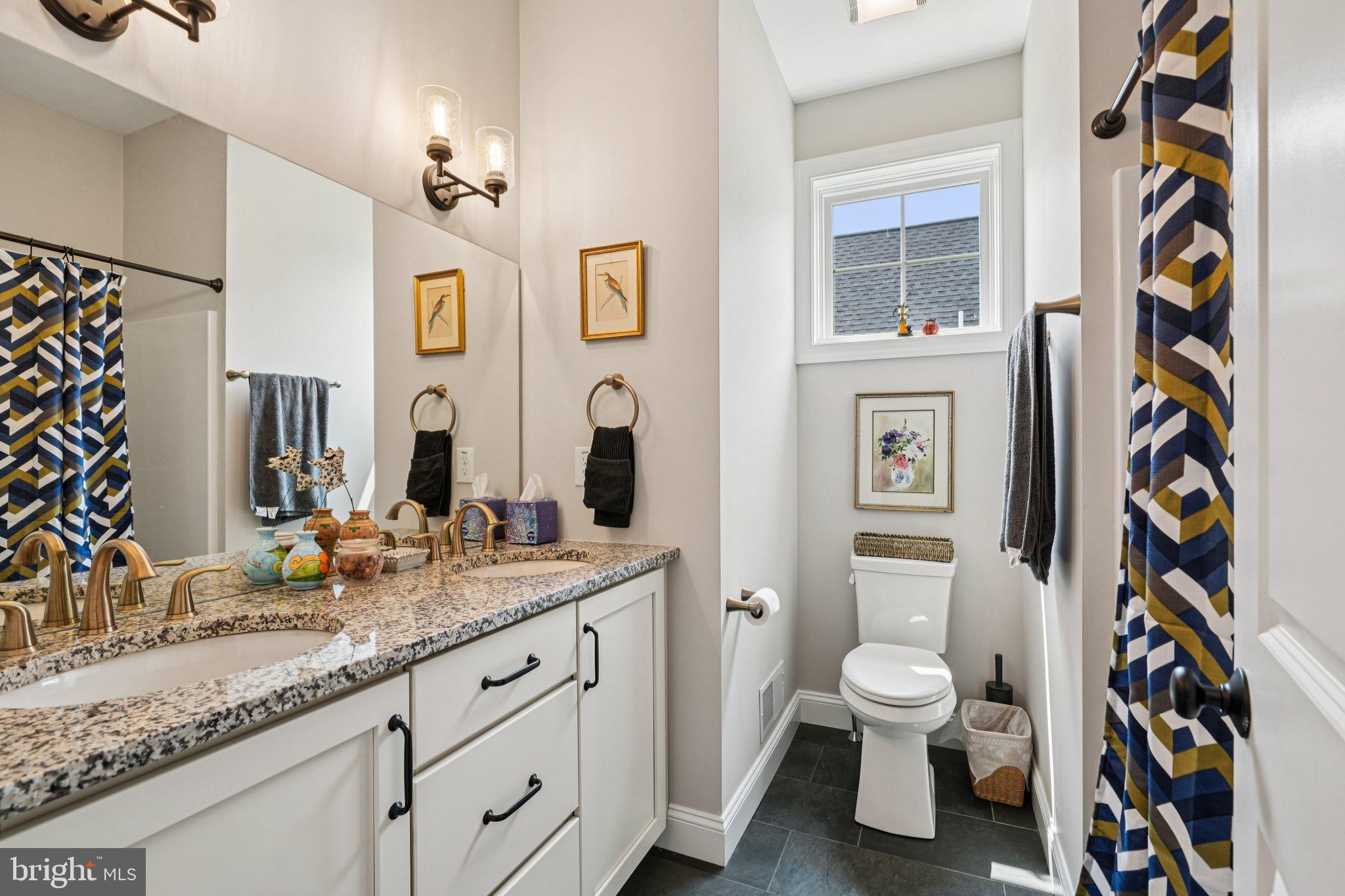 4459 Old Saucon Road Bethlehem, PA 18015 - Photo 21 of 40 a spacious bathroom with a granite countertop sink and a toilet