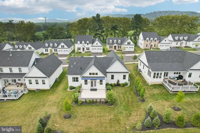 a aerial view of a house with swimming pool and a yard