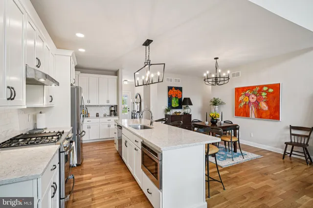 a kitchen that has a lot of cabinets a sink and a stove
