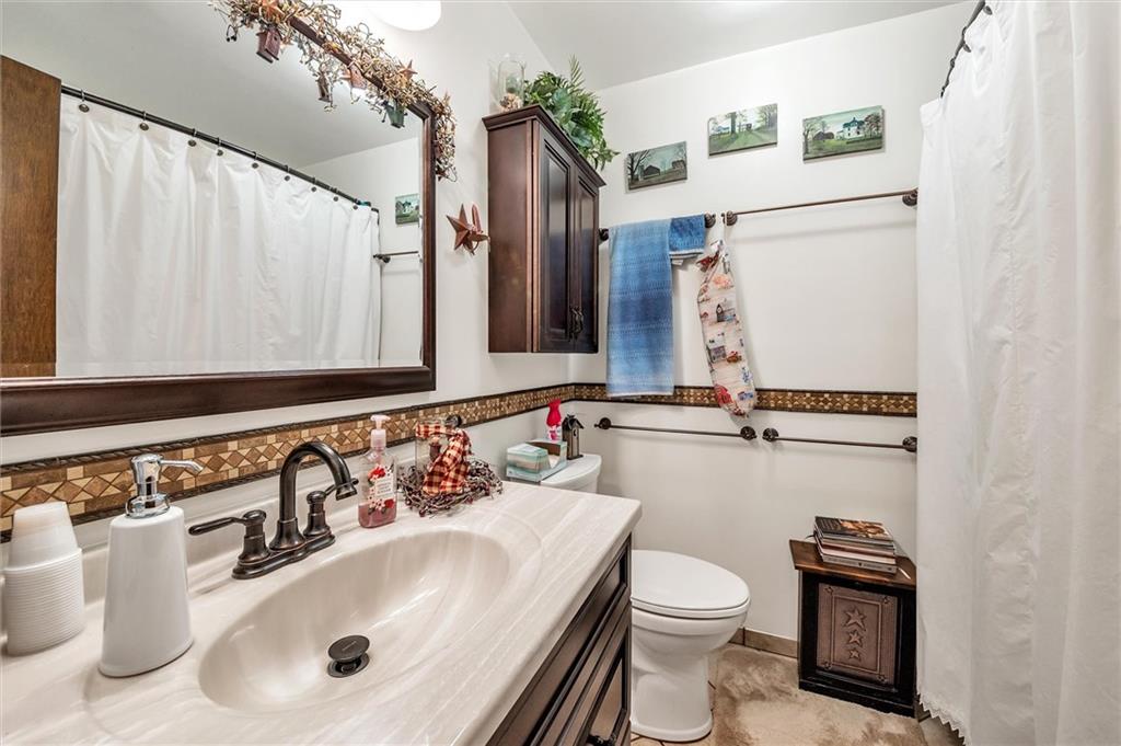 10 Rayne Church Road Indiana, PA 15701 - Photo 11 of 25 a bathroom with a sink a toilet and mirror