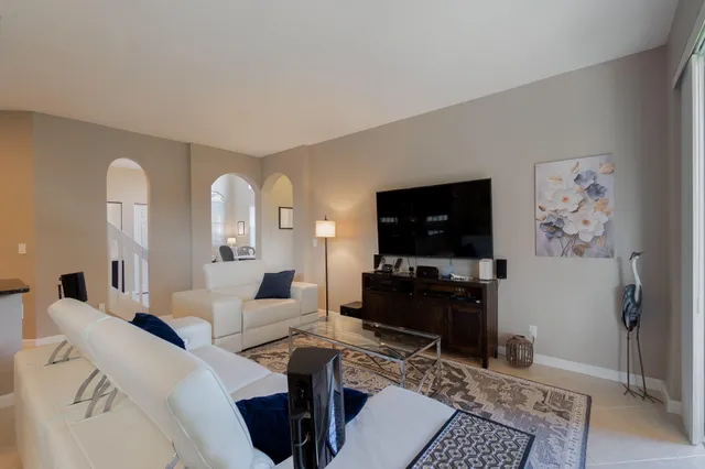 a living room with furniture and kitchen view