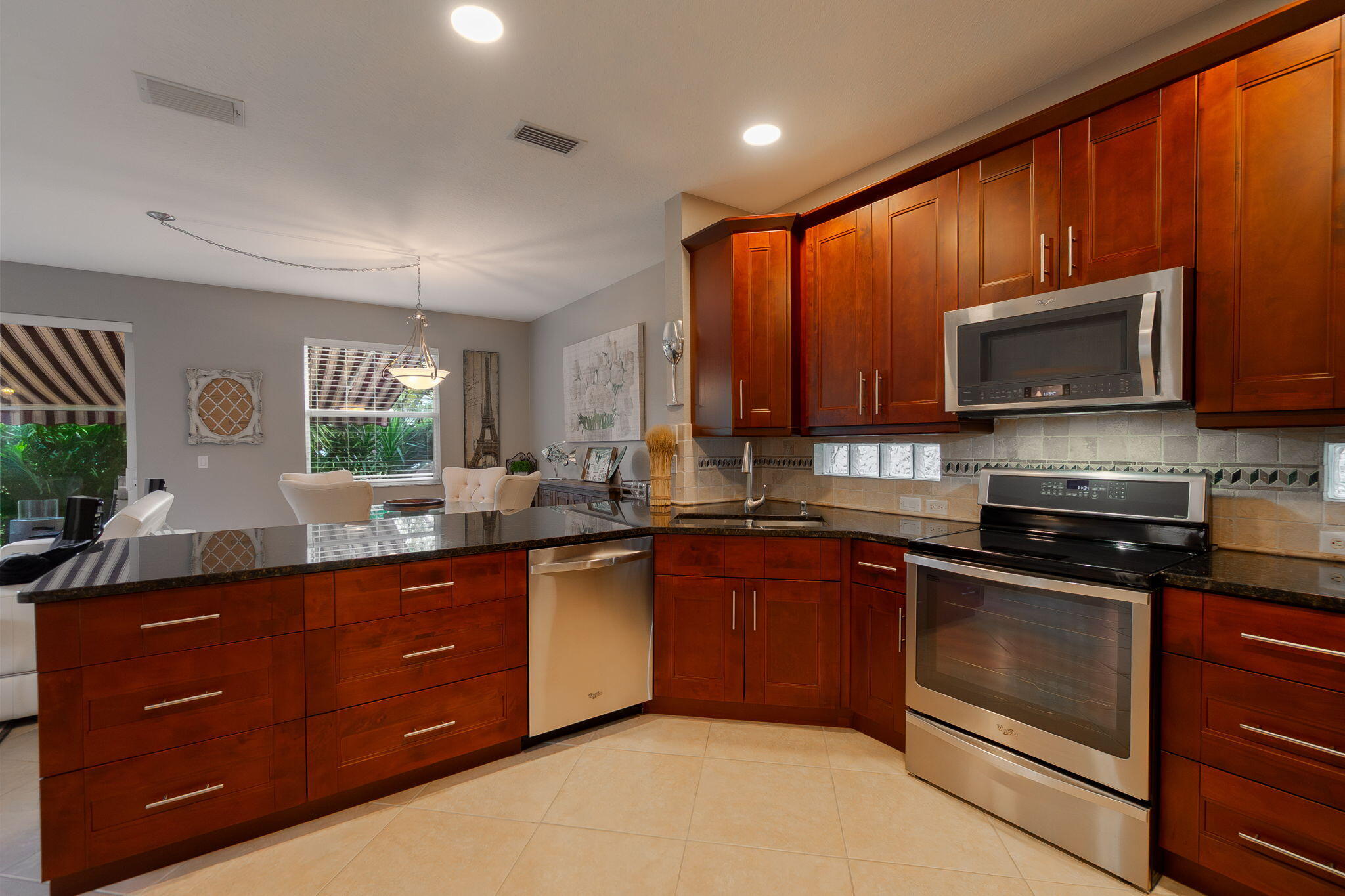 1004 Center Stone Lane Riviera Beach, FL 33404 - Photo 17 of 47 a kitchen with sink a microwave a stove and cabinets