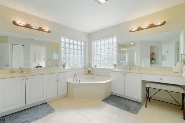 a spacious bathroom with a shower sink and mirror