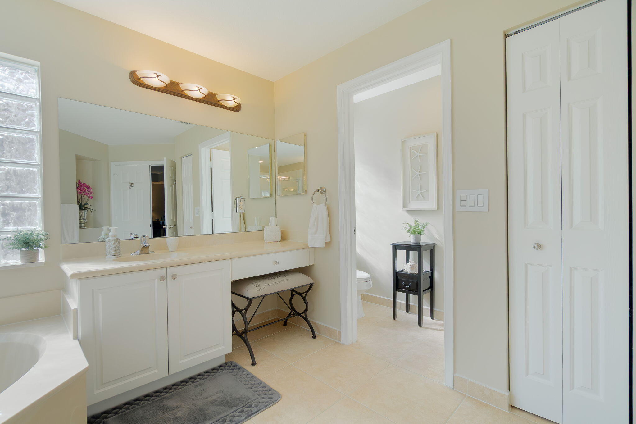 1004 Center Stone Lane Riviera Beach, FL 33404 - Photo 27 of 47 a large bathroom with a sink mirror and a shower