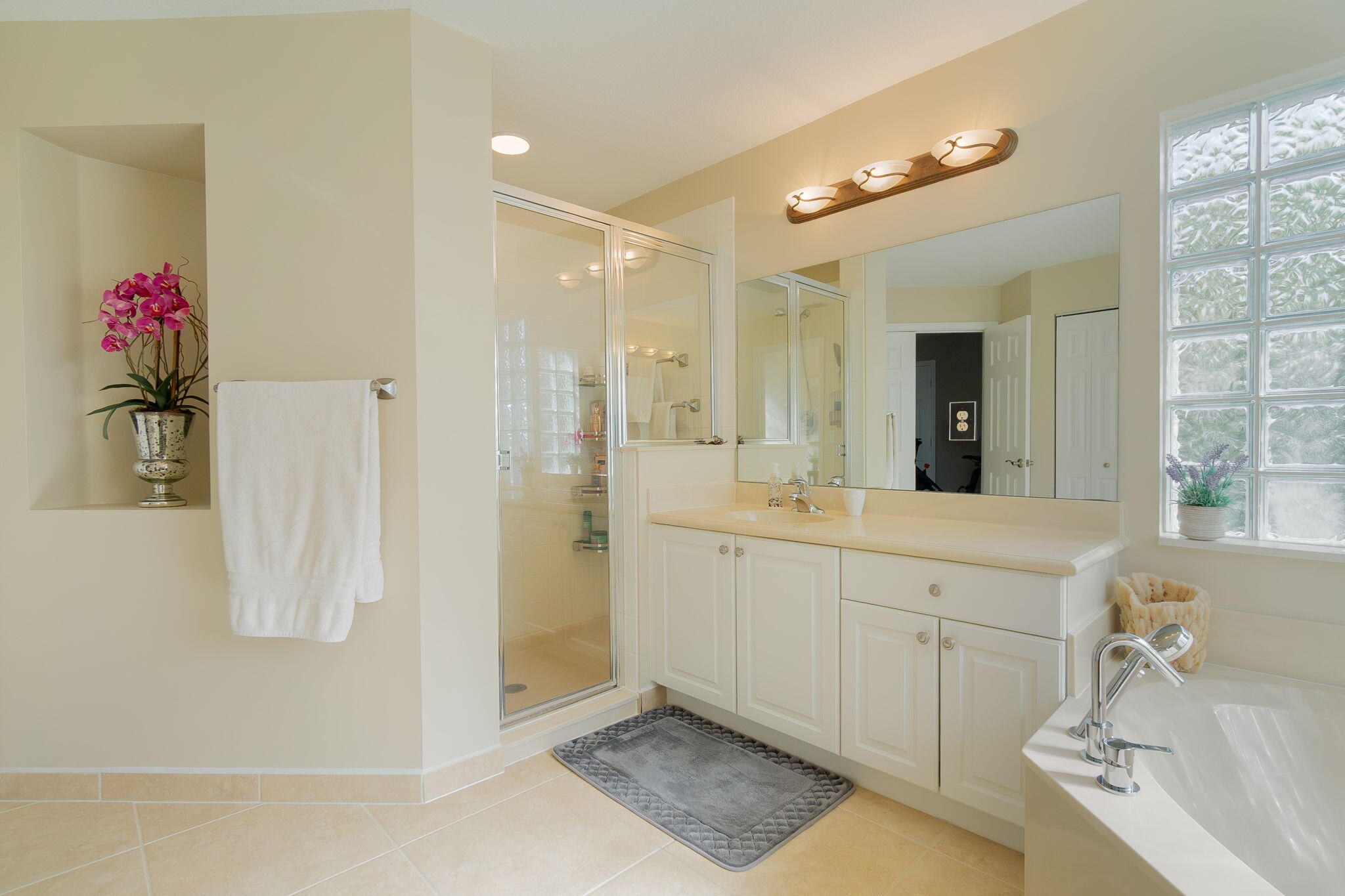 1004 Center Stone Lane Riviera Beach, FL 33404 - Photo 28 of 47 a spacious bathroom with a shower sink and mirror