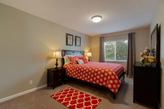 a bathroom with a toilet a window and shower