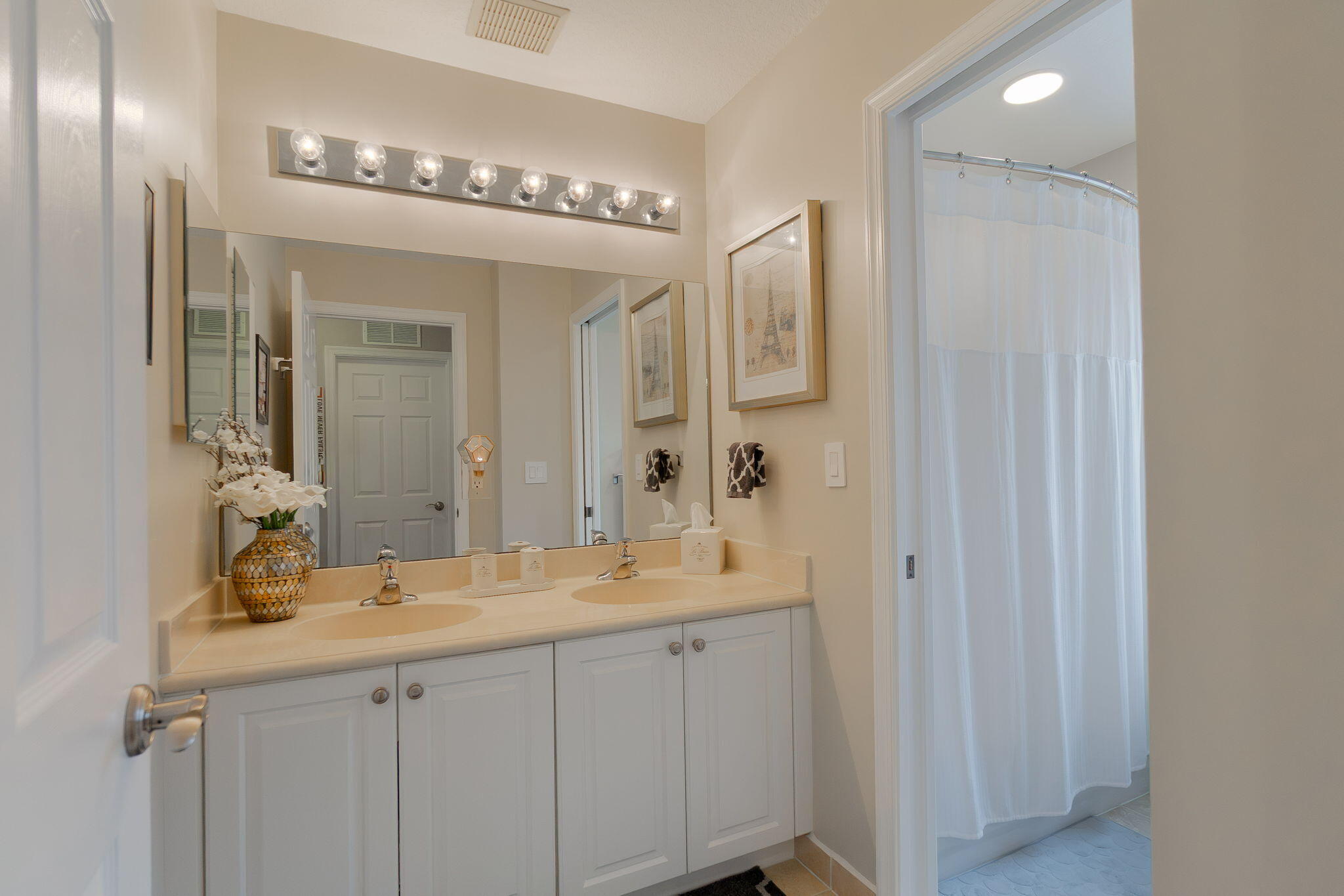 1004 Center Stone Lane Riviera Beach, FL 33404 - Photo 31 of 47 a bathroom with a double vanity sink and a mirror