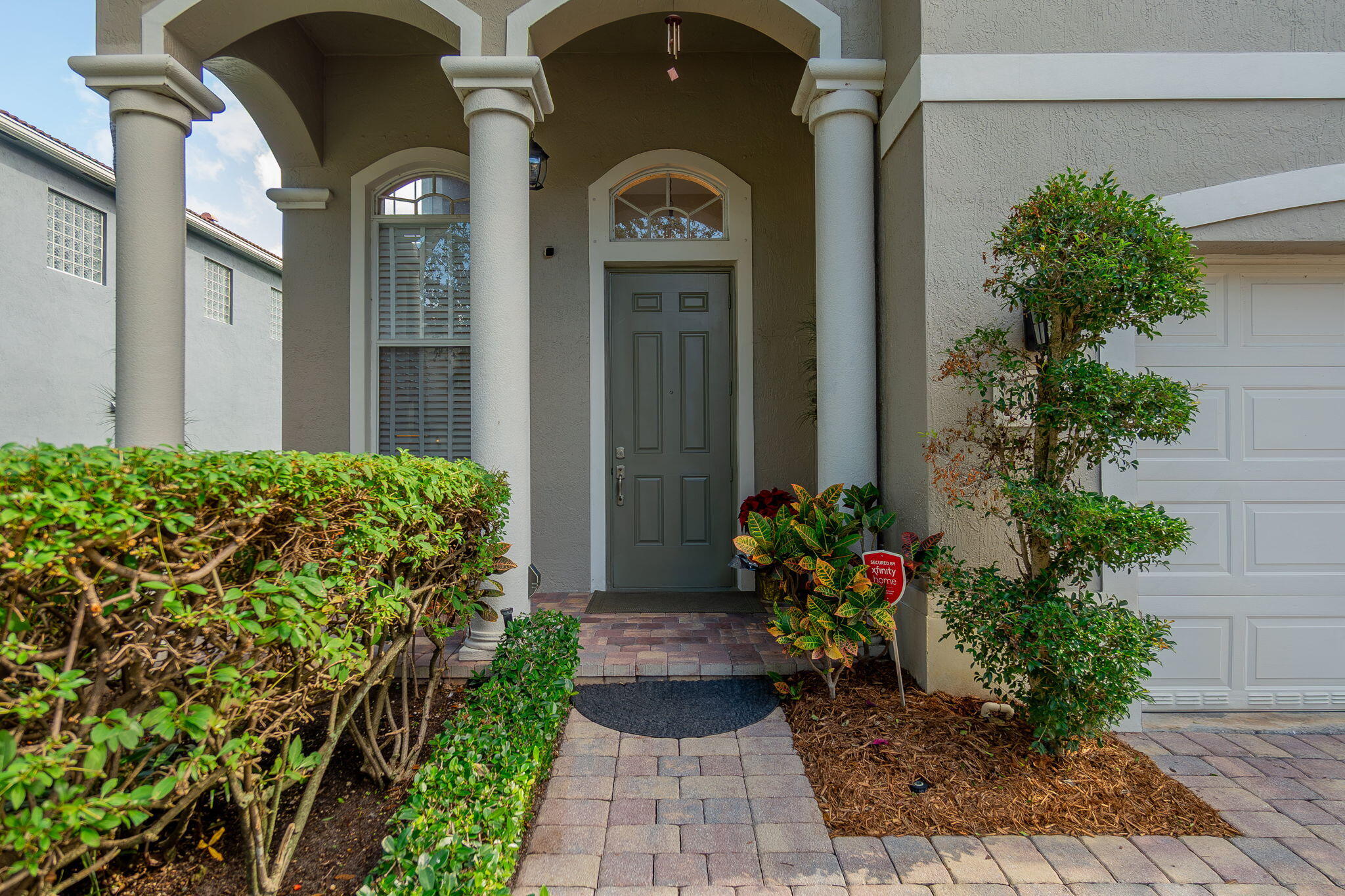 1004 Center Stone Lane Riviera Beach, FL 33404 - Photo 5 of 47 a front view of a house with a lots of flower garden