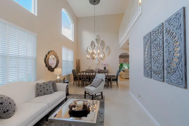 a living room with furniture chandelier and a chandelier