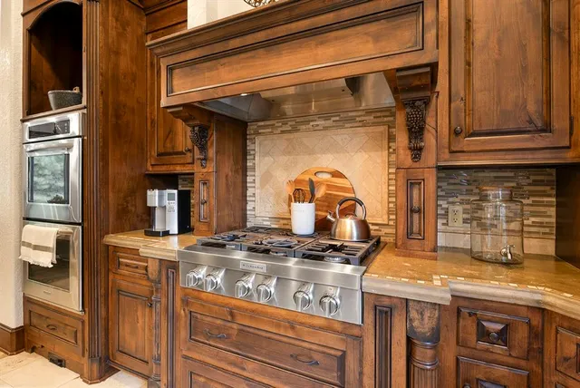 a kitchen with stainless steel appliances granite countertop a stove and a microwave