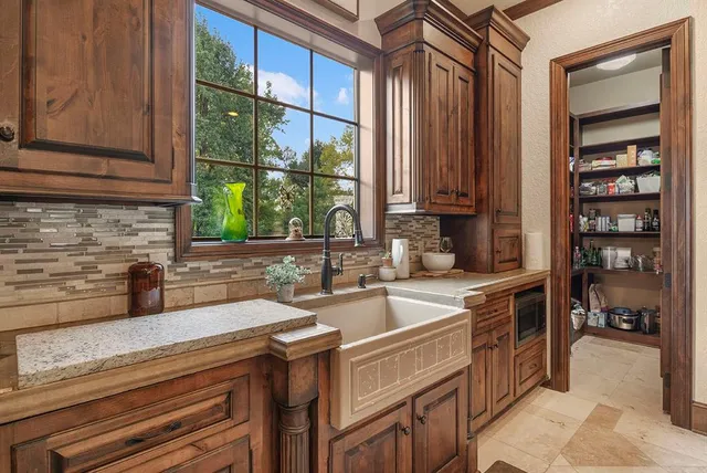 a kitchen with stainless steel appliances granite countertop a sink and a stove