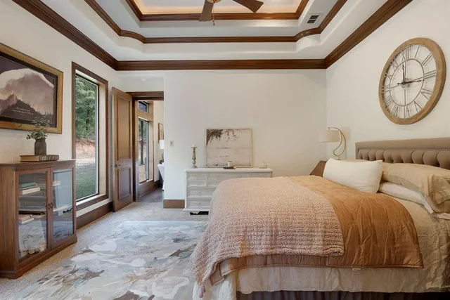 a bedroom with a bed and a large mirror on the dresser