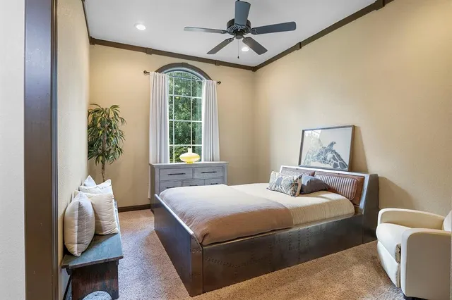 a bedroom with a bed couch and a window