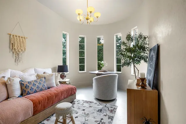 a living room with furniture and a chandelier