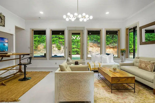 a living room with furniture and a chandelier