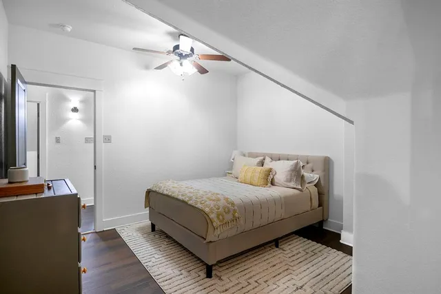 a bedroom with a bed and a mirror