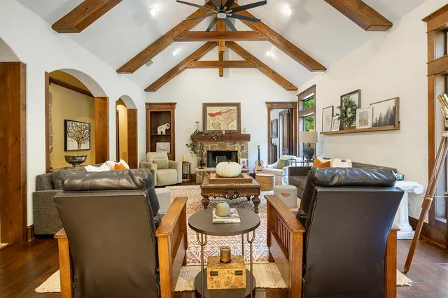 a living room with fireplace furniture and a chandelier