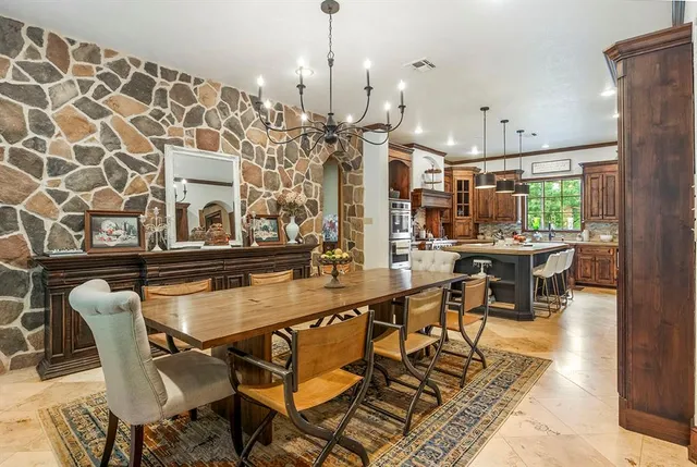a dining hall with stainless steel appliances a dining table and chairs with the wooden floor