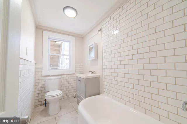 a bathroom with a white toilet and a shower