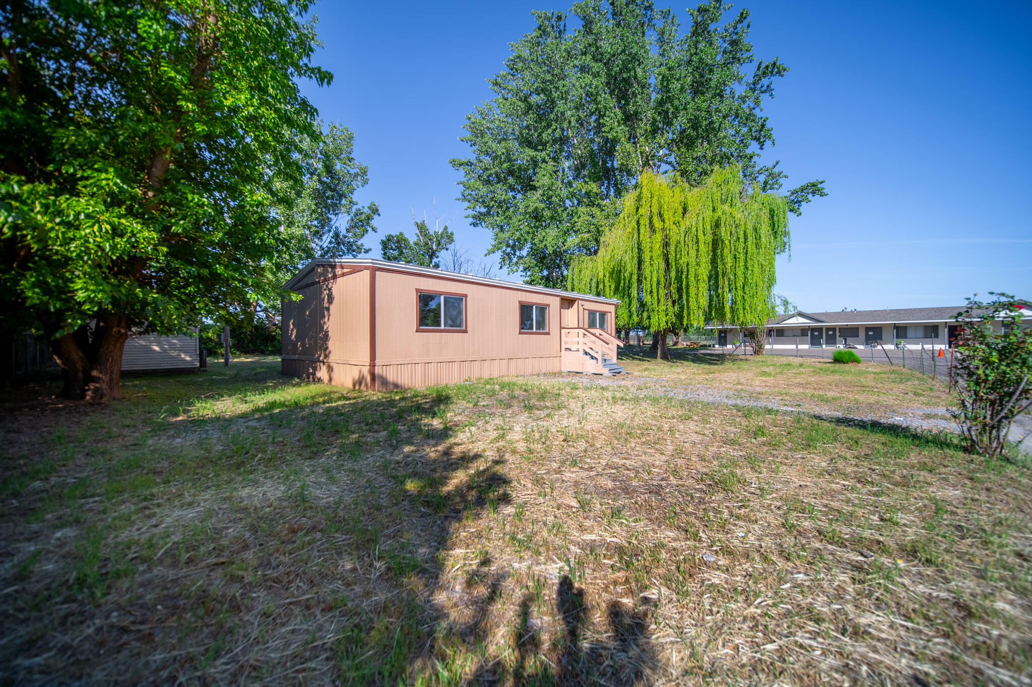 21133 Ronald Street Anderson, CA 96007 - Photo 4 of 26 a backyard of a house with lots of green space
