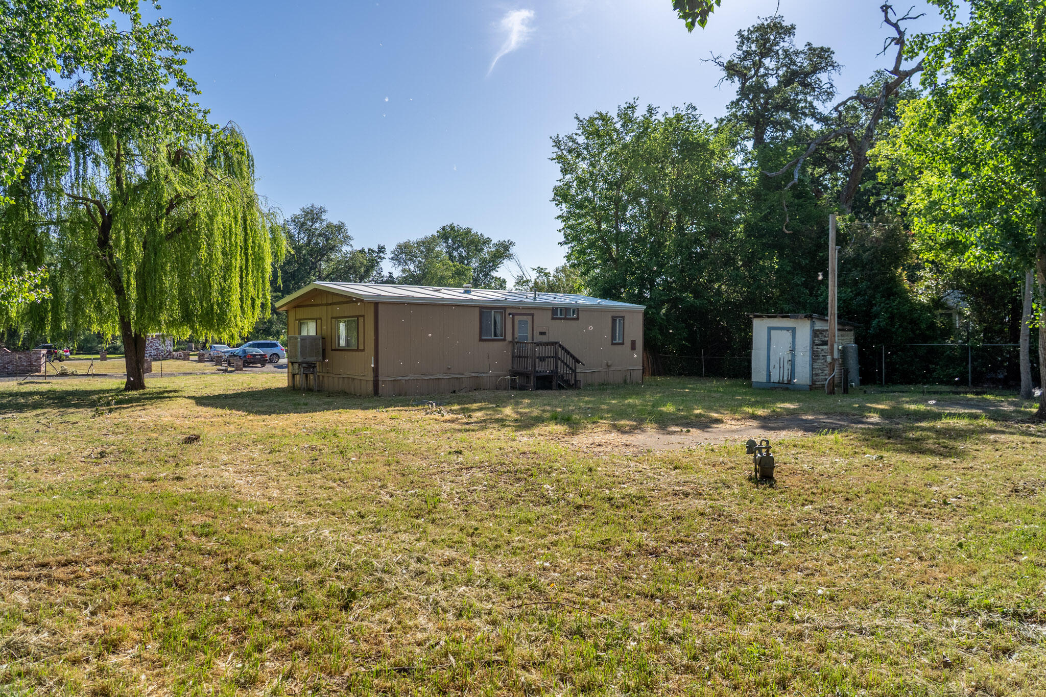 21133 Ronald Street Anderson, CA 96007 - Photo 5 of 26 a view of a house with backyard and trees