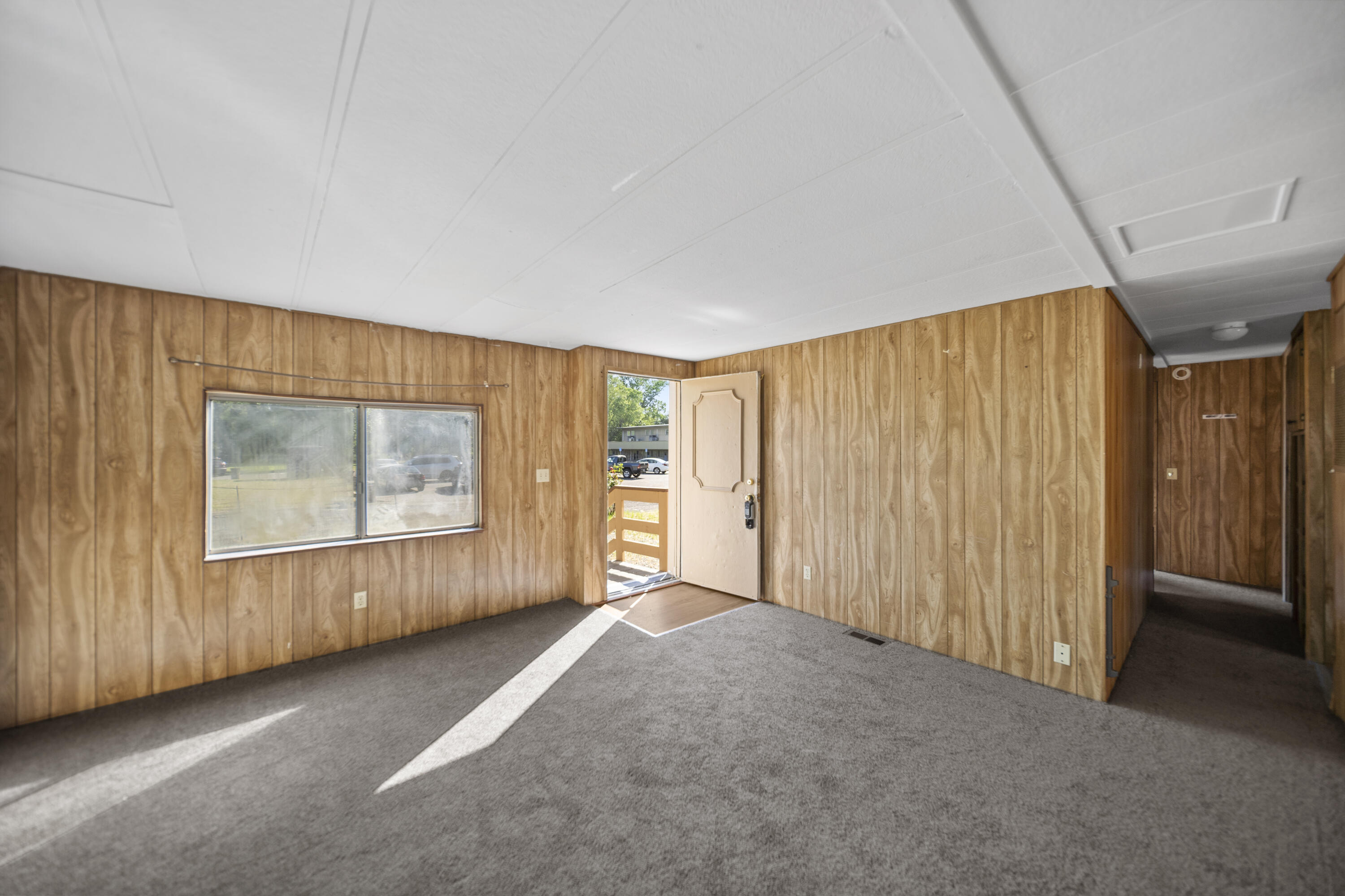 21133 Ronald Street Anderson, CA 96007 - Photo 6 of 26 a view of an empty room with a window