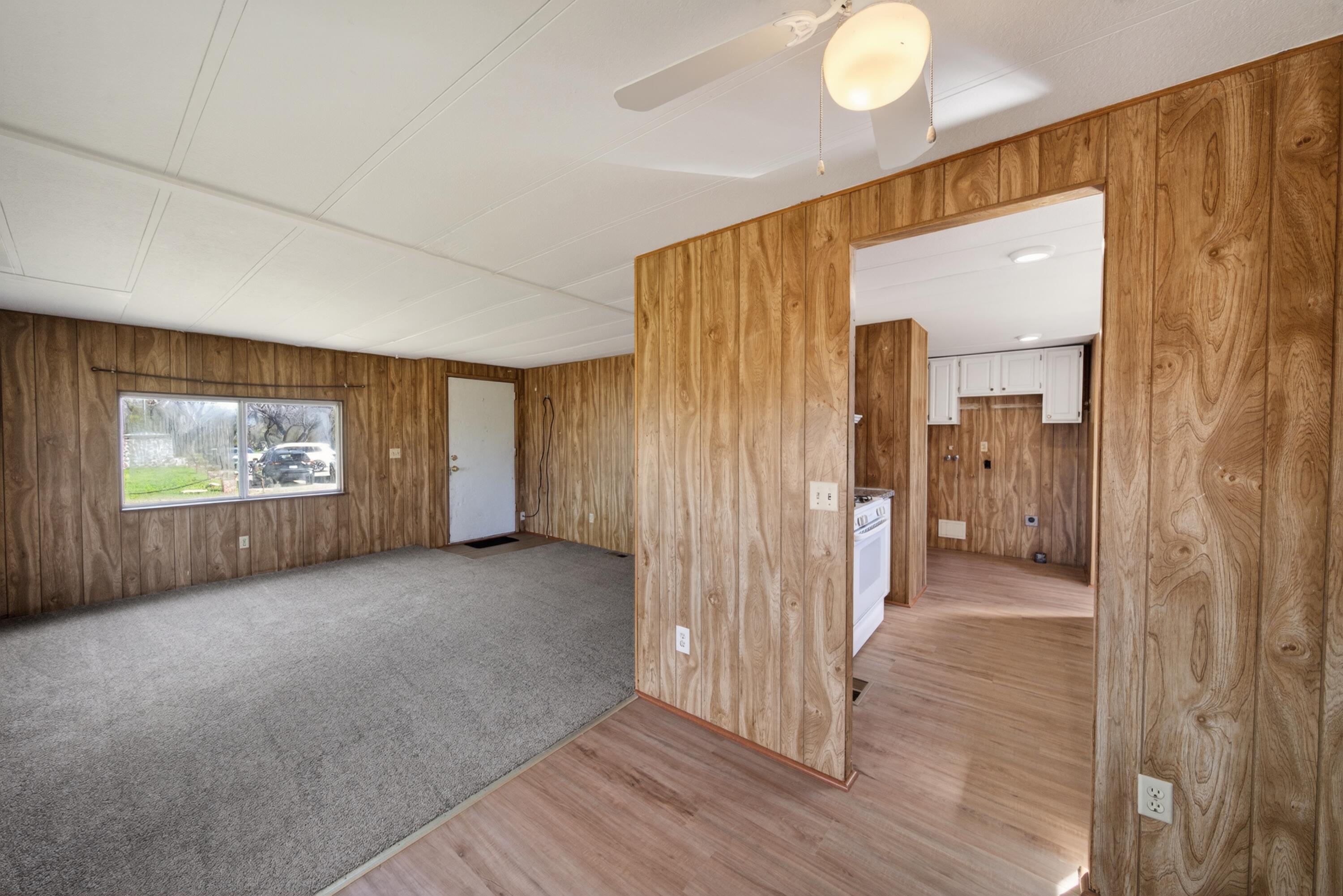21133 Ronald Street Anderson, CA 96007 - Photo 7 of 26 a view of a hallway with wooden floor and windows in a room