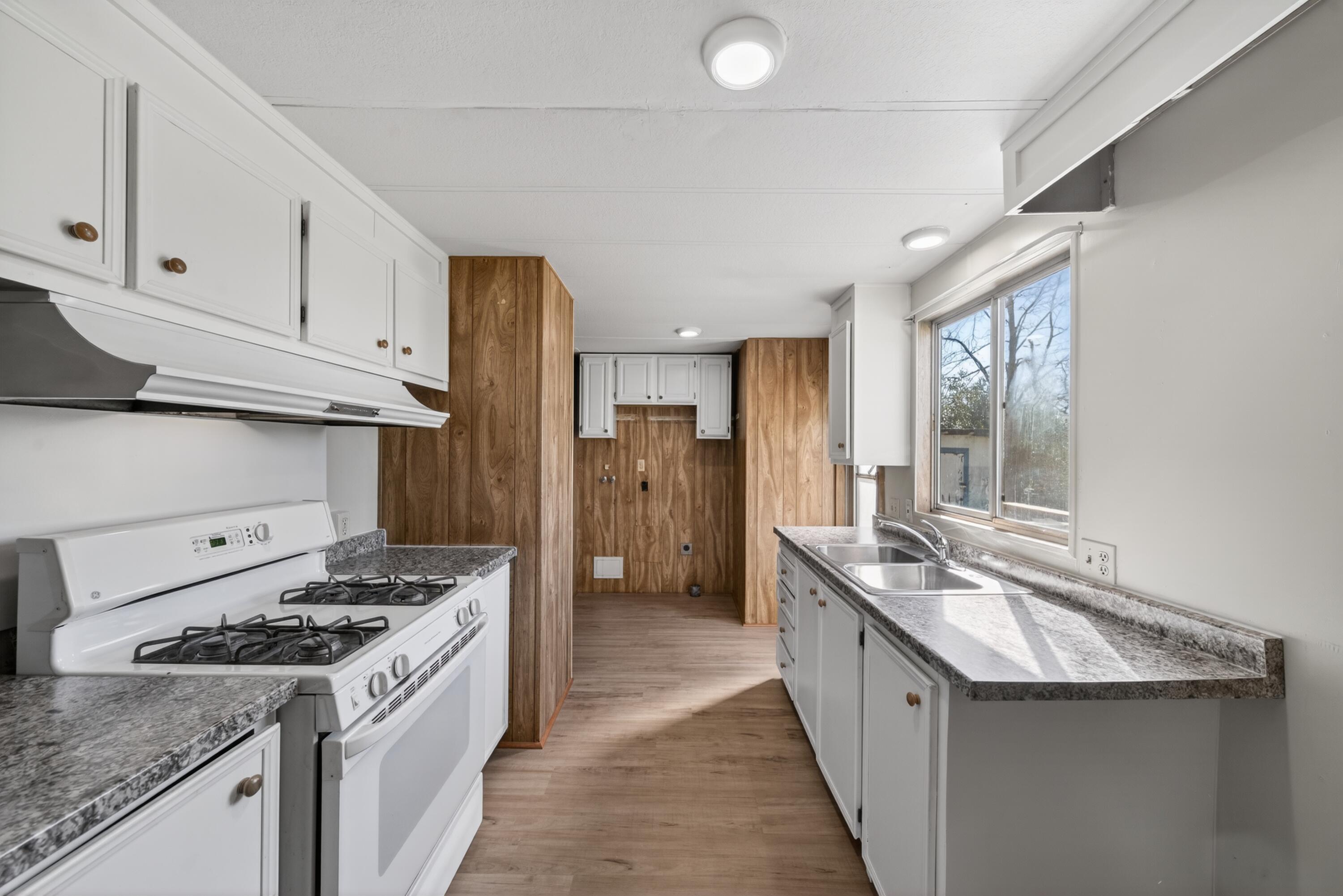 21133 Ronald Street Anderson, CA 96007 - Photo 8 of 26 a kitchen with stainless steel appliances granite countertop a sink stove and refrigerator