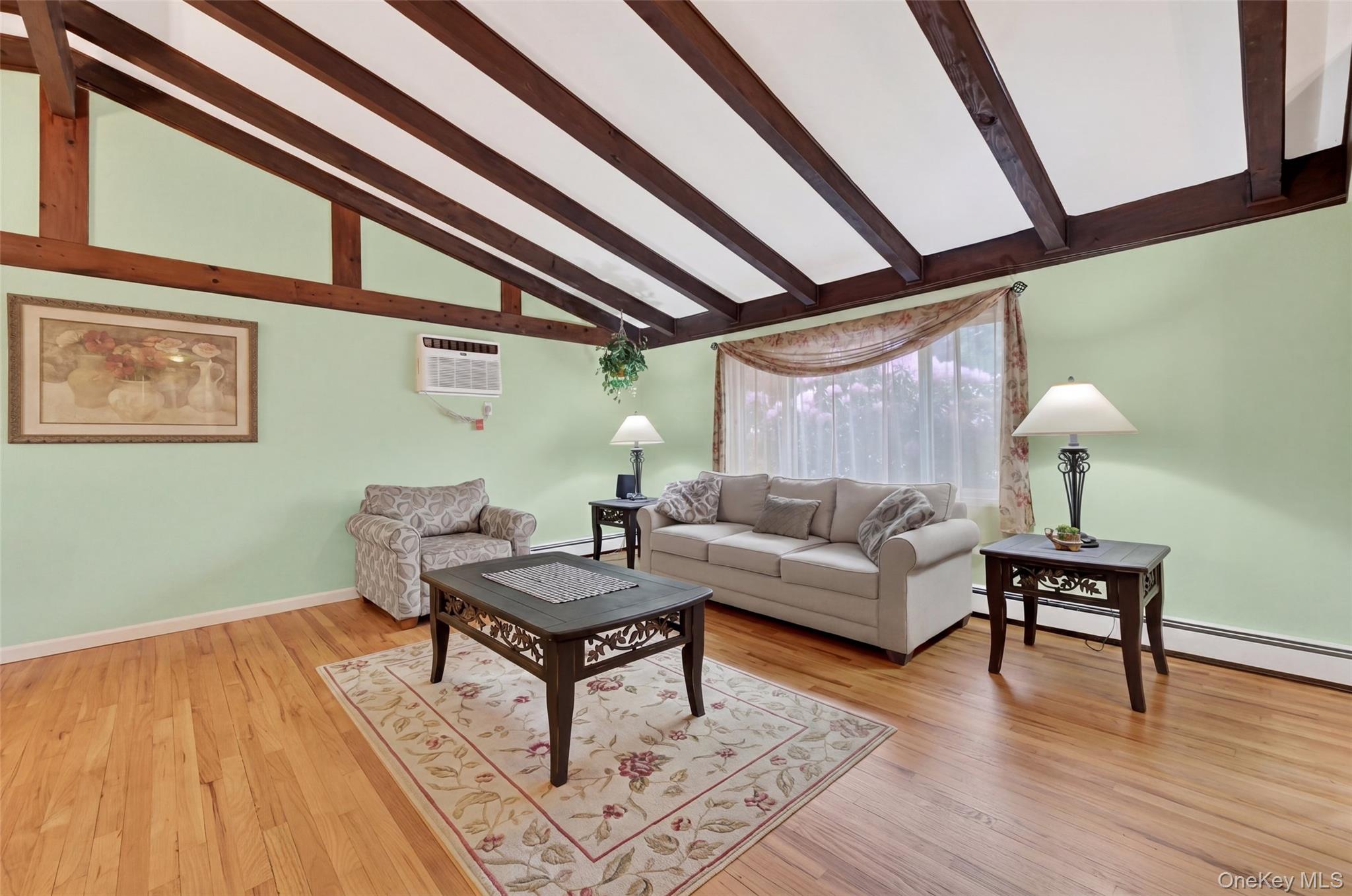 1 Rockledge Road Poughkeepsie, NY 12601 - Photo 4 of 36 Living room with Vaulted ceilings with exposed wood beams, hardwood flooring, and a large window