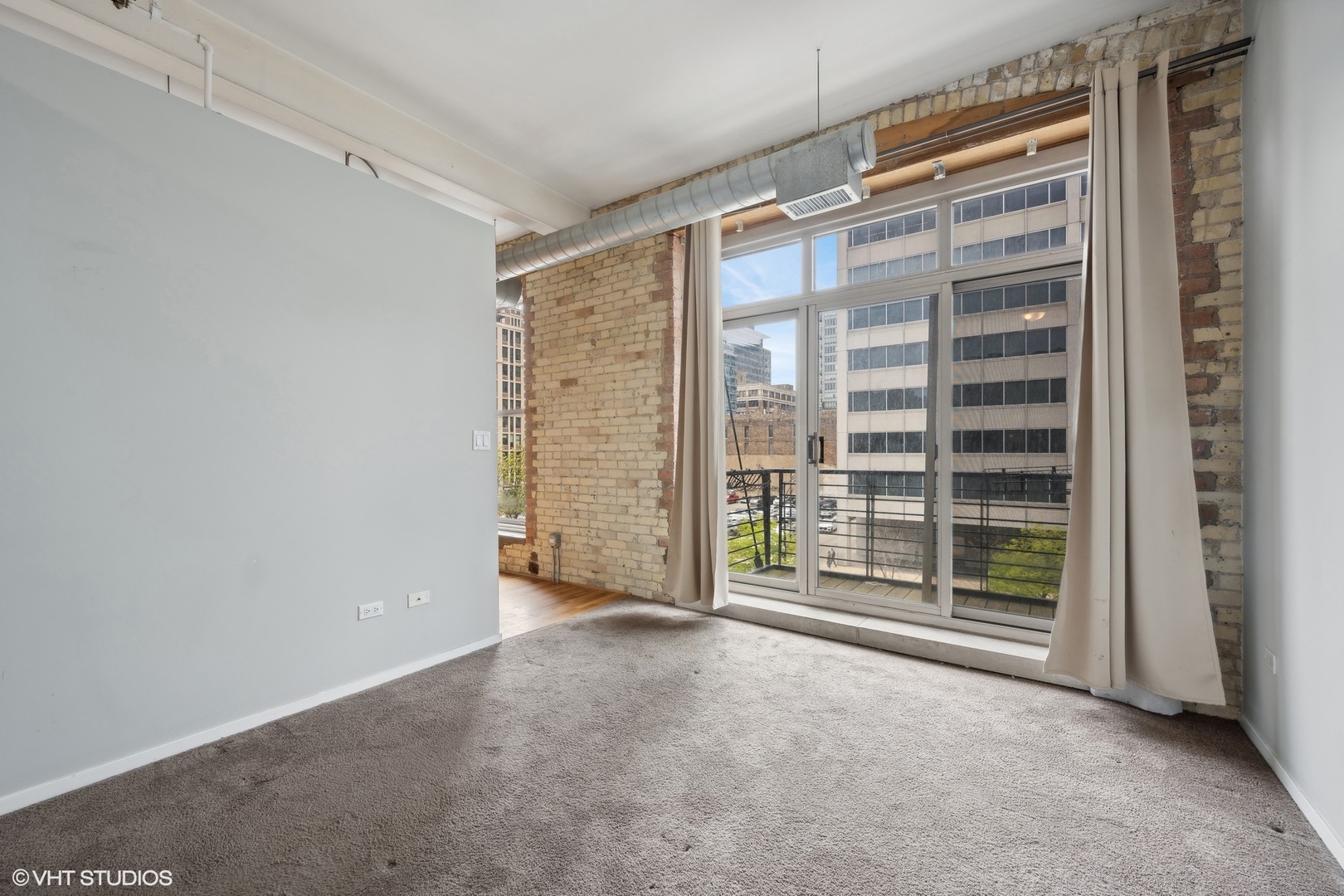 420 South Clinton Street, Unit 317A Chicago, IL 60607 - Photo 13 of 17 a view of an empty room with a fireplace