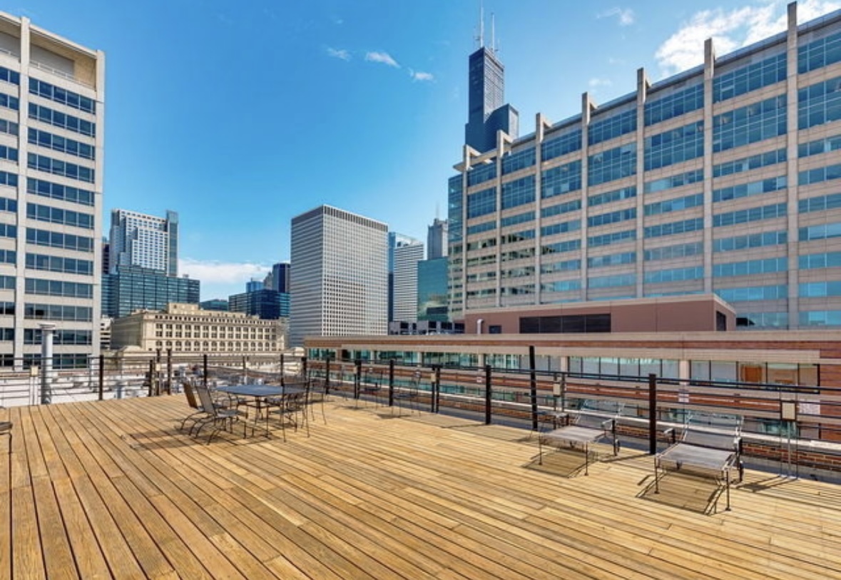420 South Clinton Street, Unit 317A Chicago, IL 60607 - Photo 16 of 17 a view of roof deck with a barbeque and wooden stairs