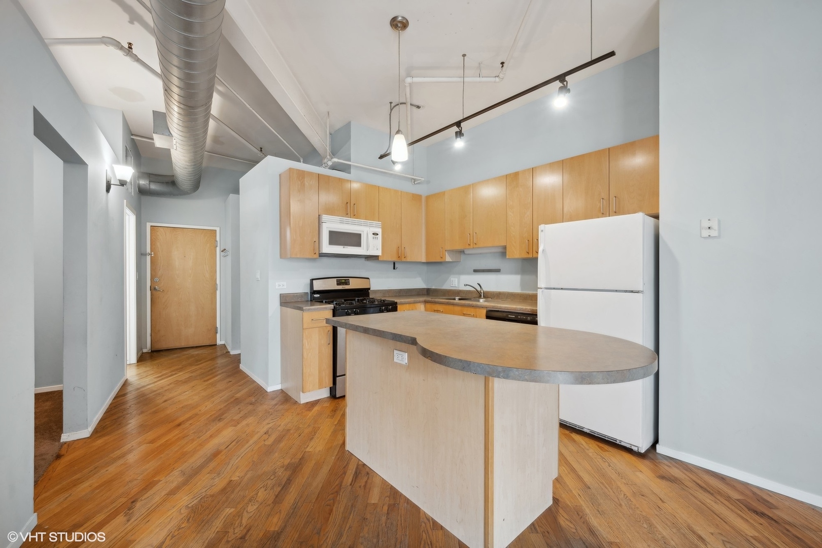 420 South Clinton Street, Unit 317A Chicago, IL 60607 - Photo 3 of 17 a kitchen with stainless steel appliances a refrigerator sink and microwave