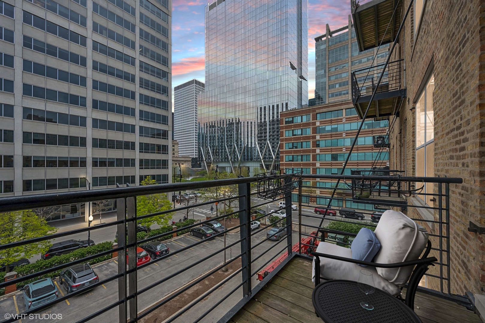 420 South Clinton Street, Unit 317A Chicago, IL 60607 - Photo 10 of 17 a view of a balcony with wooden floor and outdoor seating