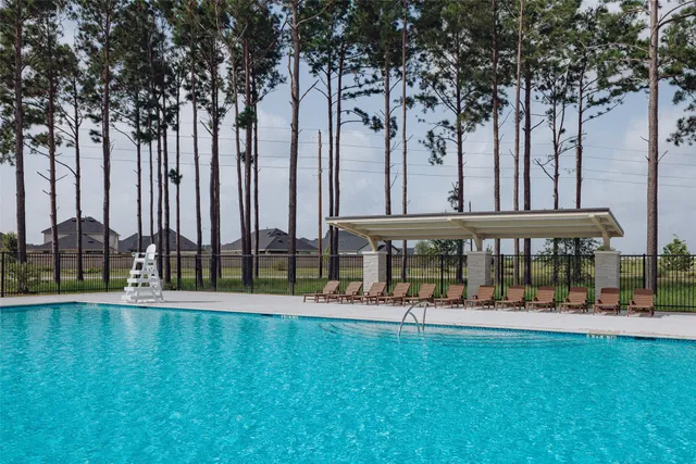 a swimming pool with outdoor seating and outdoor seating