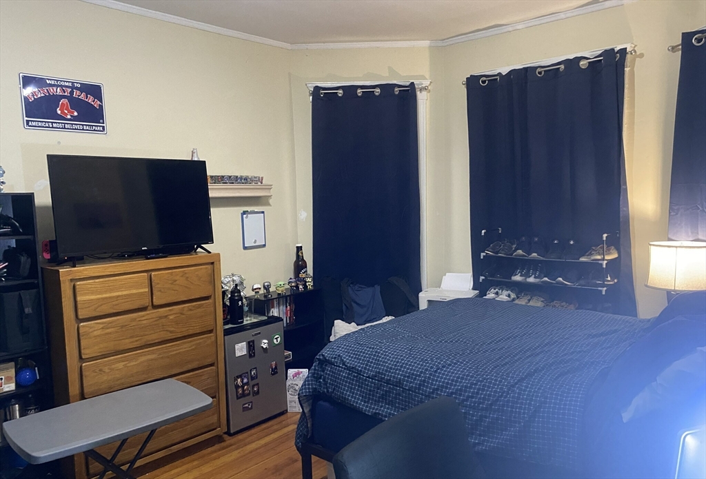 2 Imrie Road, Unit 1 Boston, MA 02134 - Photo 2 of 6 a bedroom with a bed and wooden floor