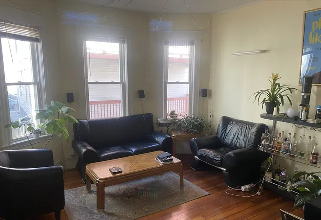 a kitchen with a refrigerator and a stove top oven