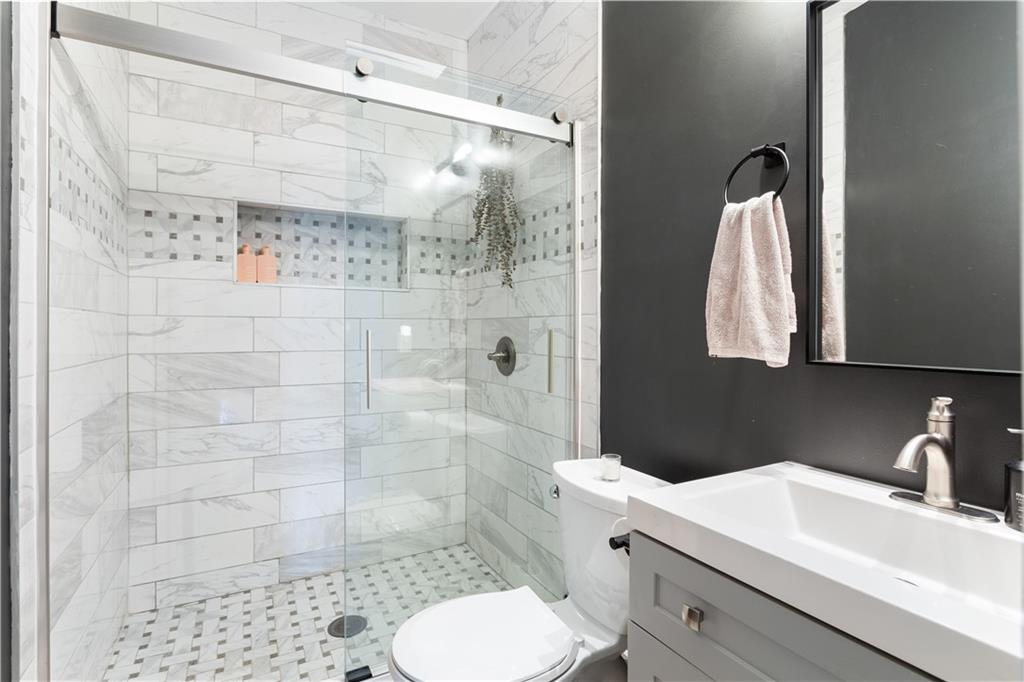 1010 Dill Avenue Southwest Atlanta, GA 30310 - Photo 19 of 39 a bathroom with a sink toilet and shower