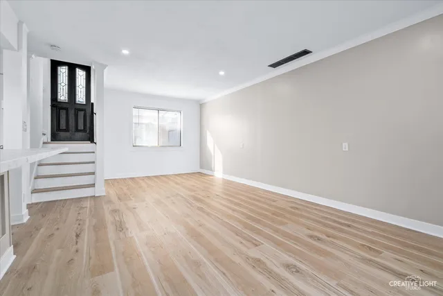 a view of a kitchen with wooden floor and windows