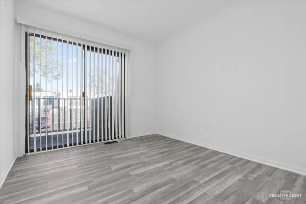 a view of room with wooden floor