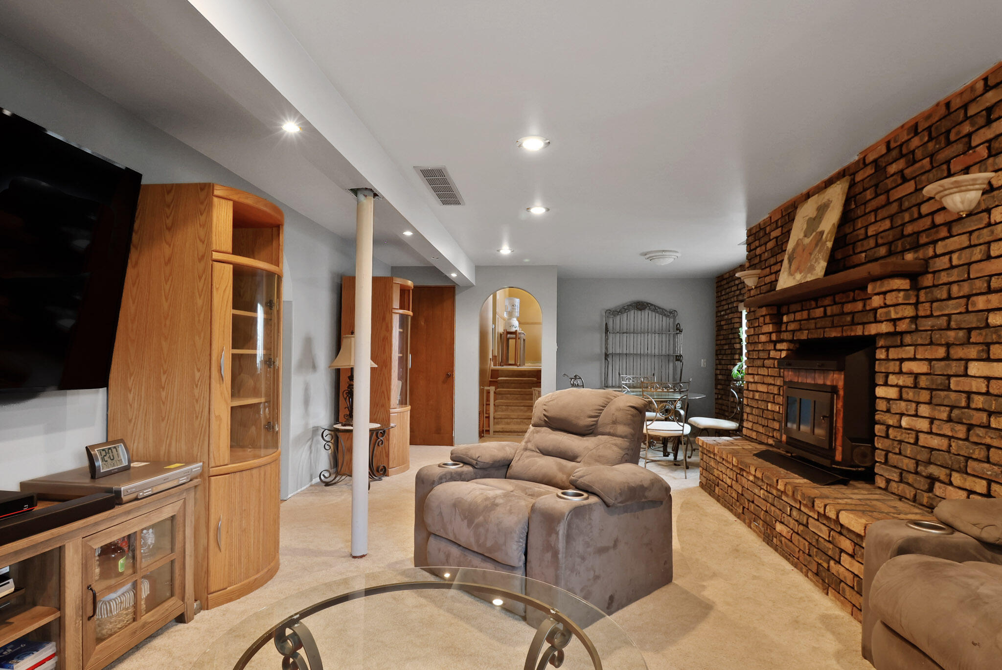 279 Robbie Lane Valparaiso, IN 46385 - Photo 23 of 35 a living room with furniture a fireplace and a flat screen tv