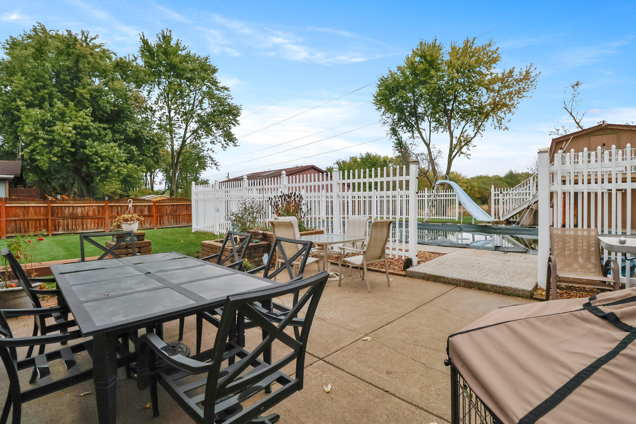 279 Robbie Lane Valparaiso, IN 46385 - Photo 25 of 35 a view of a patio with table and chairs and potted plants with wooden floor and fence