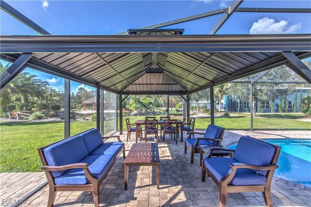 20051-071 Welborn Road North Fort Myers, FL 33917 - Photo 10 of 35 a patio with a table chairs and a umbrella