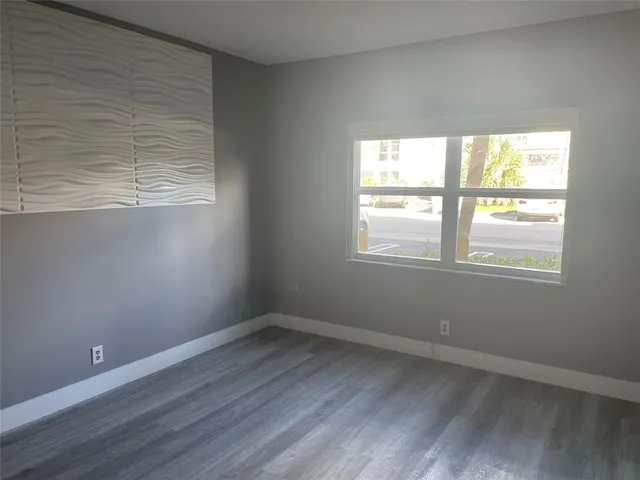 a view of a hallway with windows and chandelier