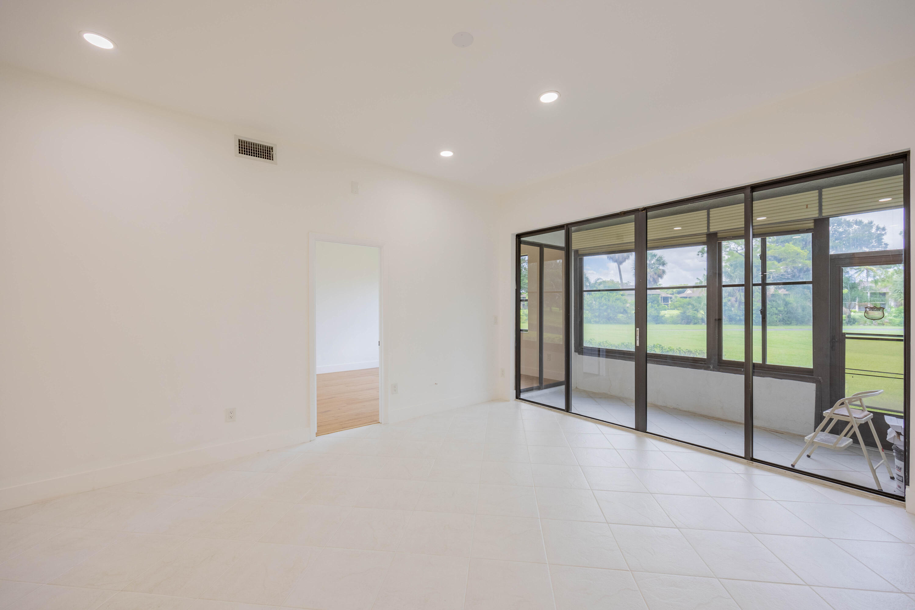 7520 La Paz Boulevard, Unit 104 Boca Raton, FL 33433 - Photo 19 of 56 a view of an empty room with windows