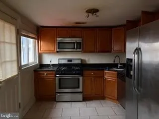 a kitchen with a refrigerator stove and microwave