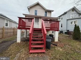 a view of a house with wooden floor and a fence
