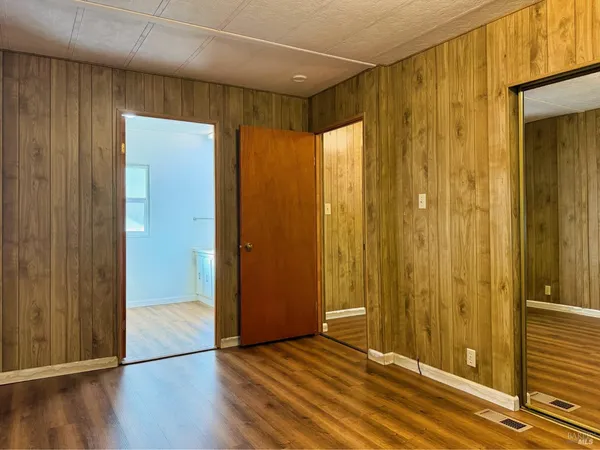a view of hallway with wooden floor