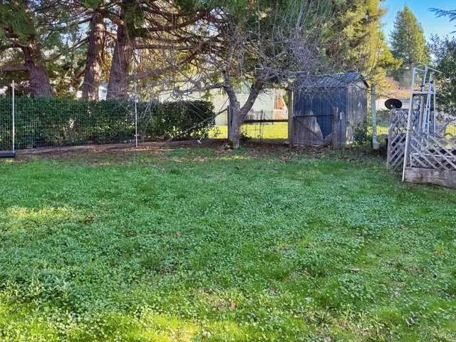 a backyard of a house with table and chairs